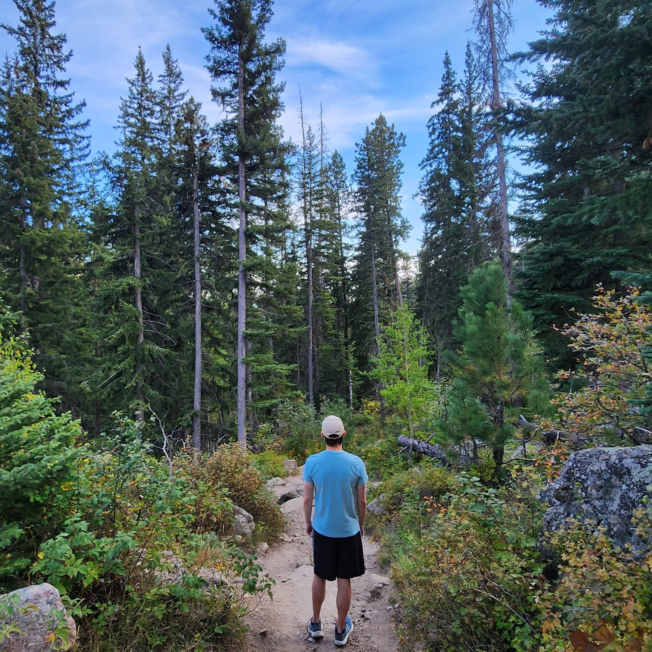 Photo of Matt on a dirt path surrounded by trees