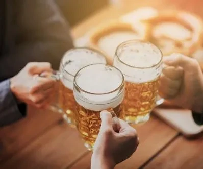 Three beers being clinked together